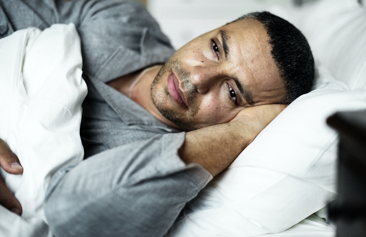 man-depressed-in-bed