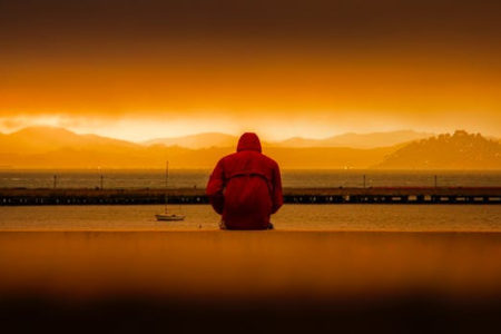 a man sitting by the sea