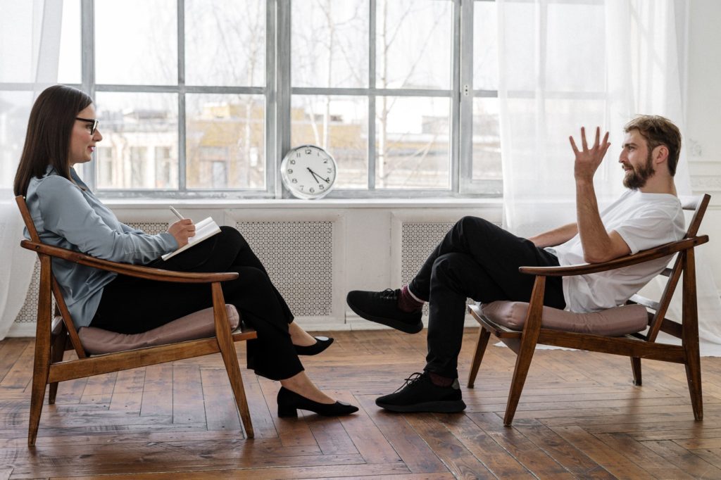 Young man in a therapy session discussing his mental health disorder