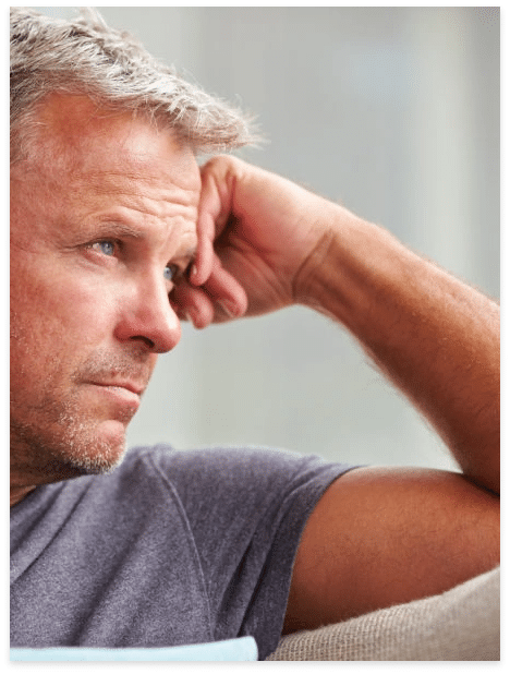 Depressed adult man with hands on chin in need of mental health and substance abuse treatment