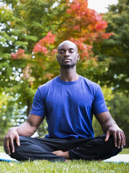 Adult man meditating in the garden as part of his therapeutic recreation.