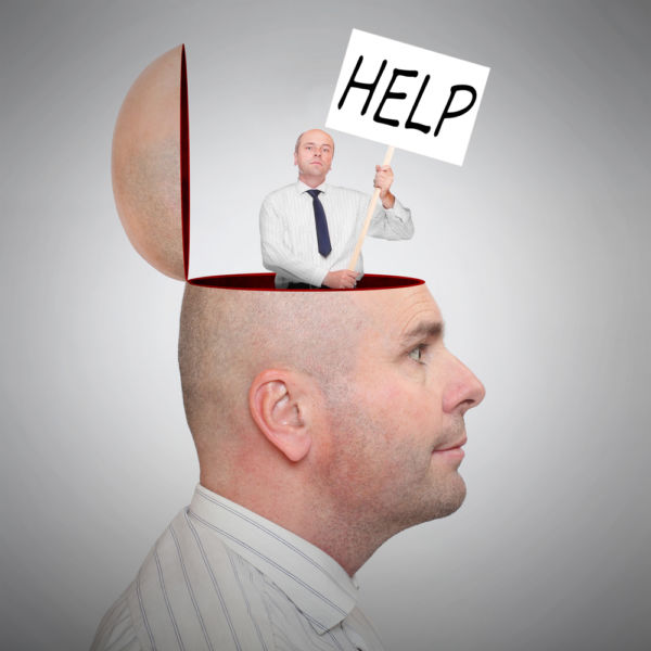 Adult male holding a help sign on top of a head concept image for mental illness and bipolar disorder symptoms