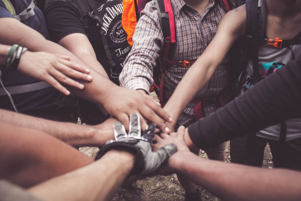 close up of multiple hands together as a team A team of men seeking treatment from the amazing team at Alta Loma in Georgetown, TX