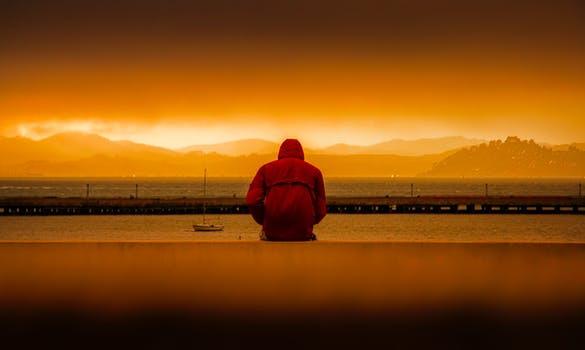 a man sitting by the sea