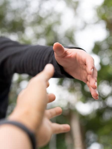 Cropped image of a hand reaching another hand for help