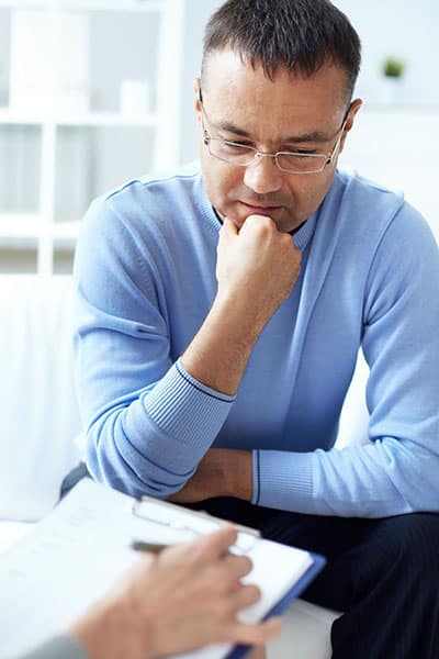 Adult man undergoing Schizoaffective disorder therapy session.