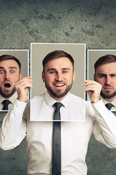 Man having different personalities. man showing cards of different personalities