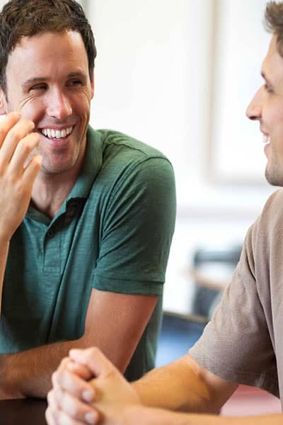 Two adult man conversing during the group therapy session for schizoaffective disorder.