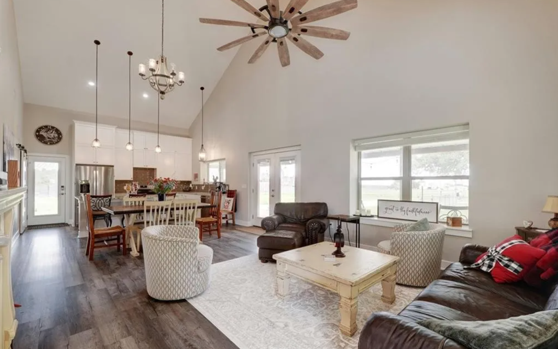 Living room with a ceiling fan, neutral tones, and comfortable seating
