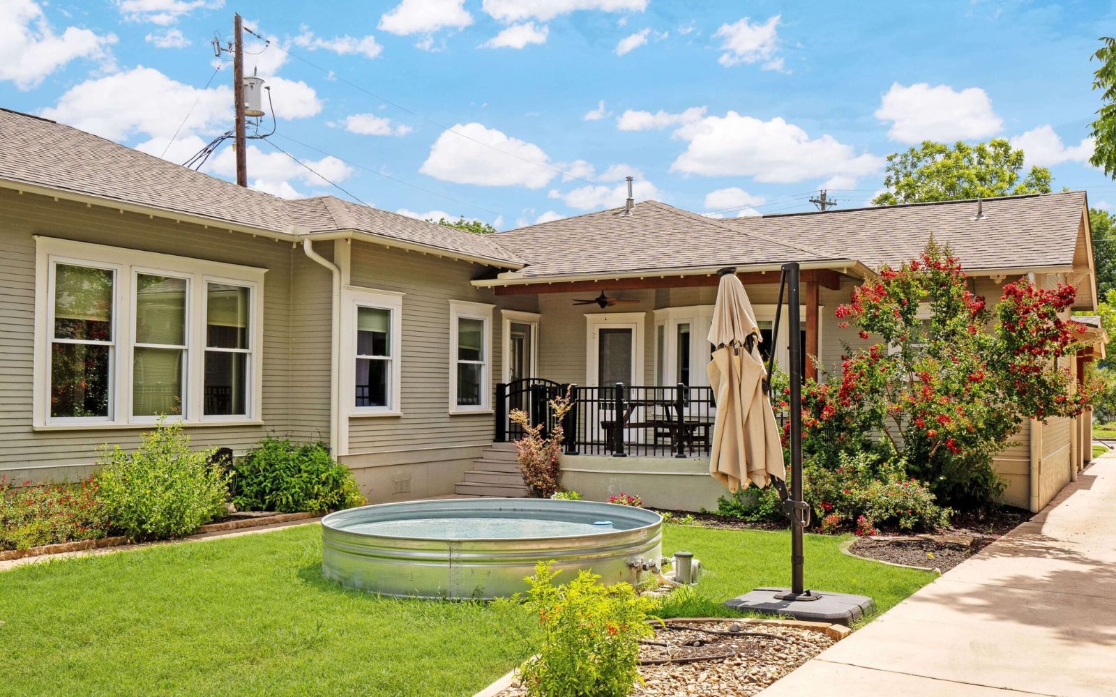 Exterior of a single-story residential home with a manicured front lawn
