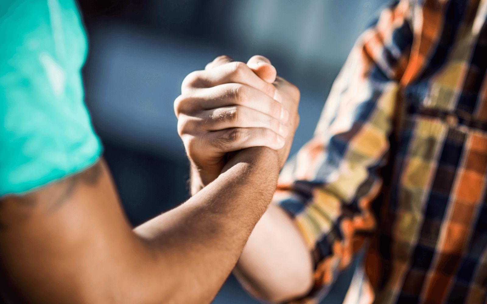 Two people holding hands in a gesture of comfort or connection